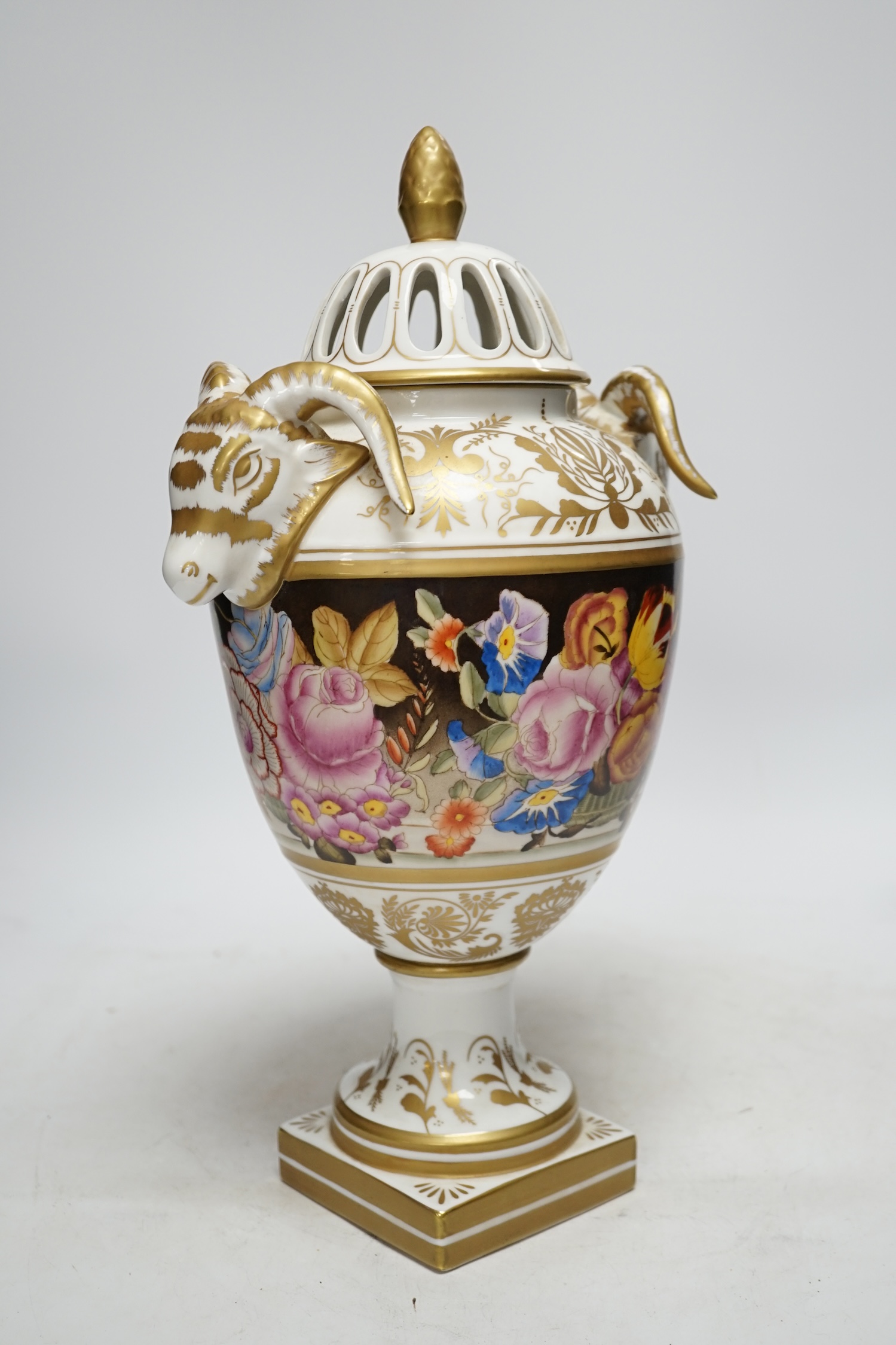 A late 20th century ‘rams head’ porcelain urn and cover, 38cm